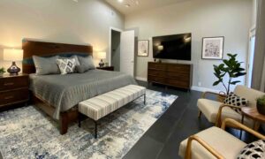 Modern hill country master bedroom seating area grey and blue color palette