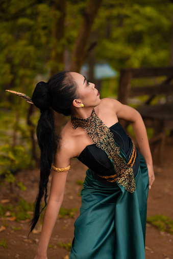 https://chrysalissa.com/wp-content/uploads/2024/01/an-indonesian-woman-poses-with-black-hair-dangling-to-the-ground-while-wearing-a-green-dance.jpg